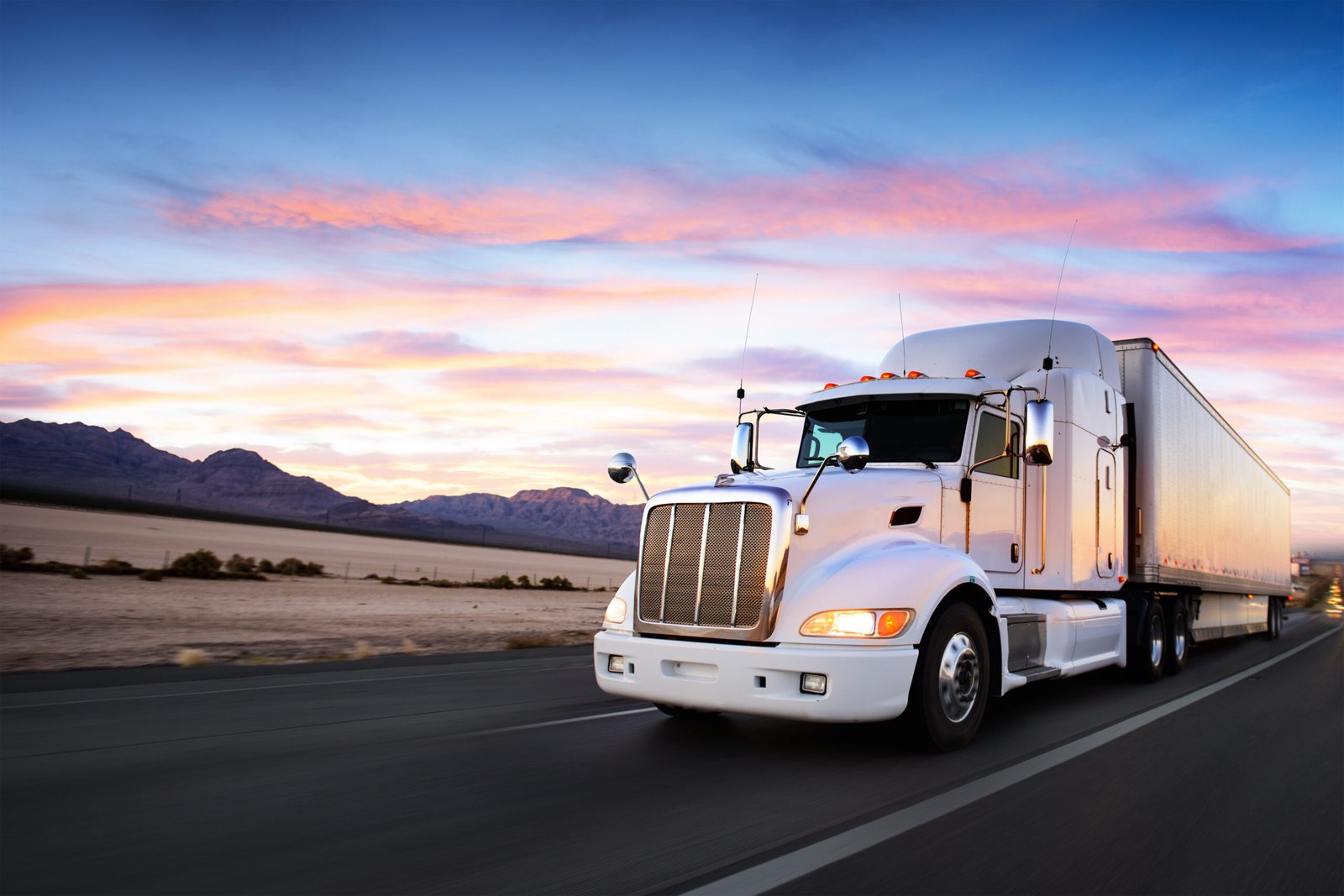 Truck and highway at sunset - transportation background